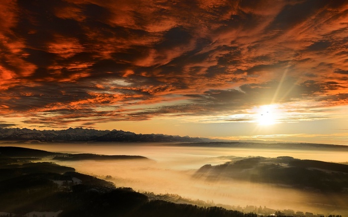 Sunset over misty mountains and valleys