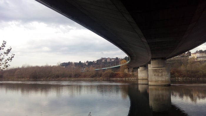 Bridge over a river with a town on a hill