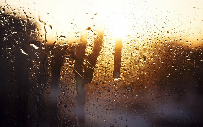 Sunlight through a window with water droplets
