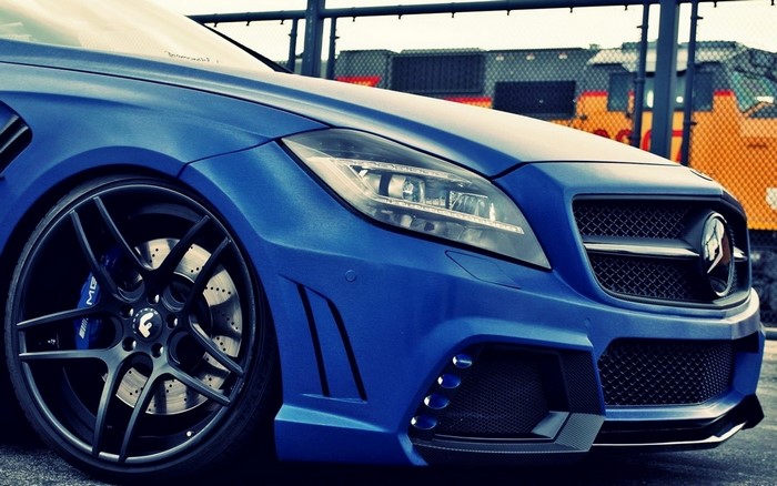 Blue Mercedes Benz CLS 63 AMG sports car with custom rims