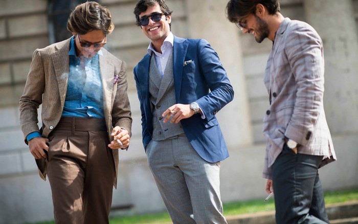 Three men in suits smoking cigarettes