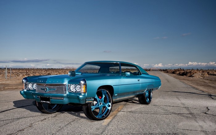 Blue Chevrolet Caprice Classic on a Desert Road