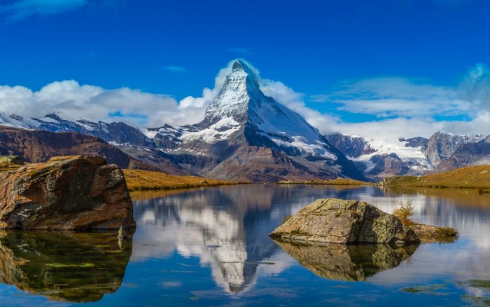 Matterhorn mountain reflected in a lake in the Alps