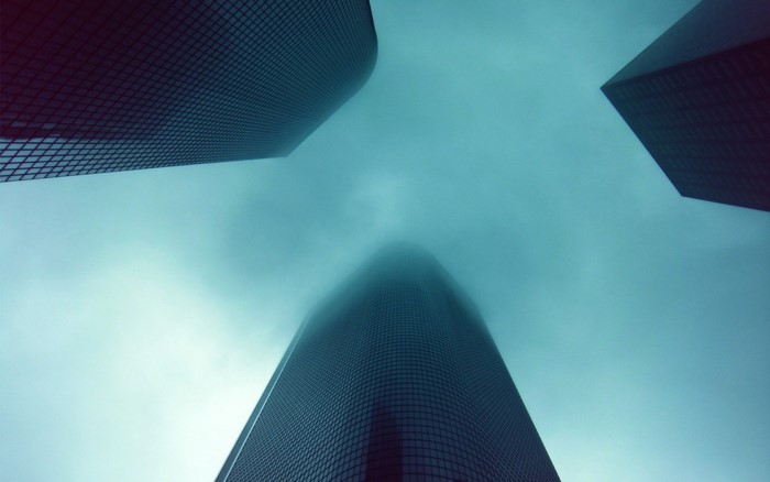 Skyscrapers shrouded in fog, looking up