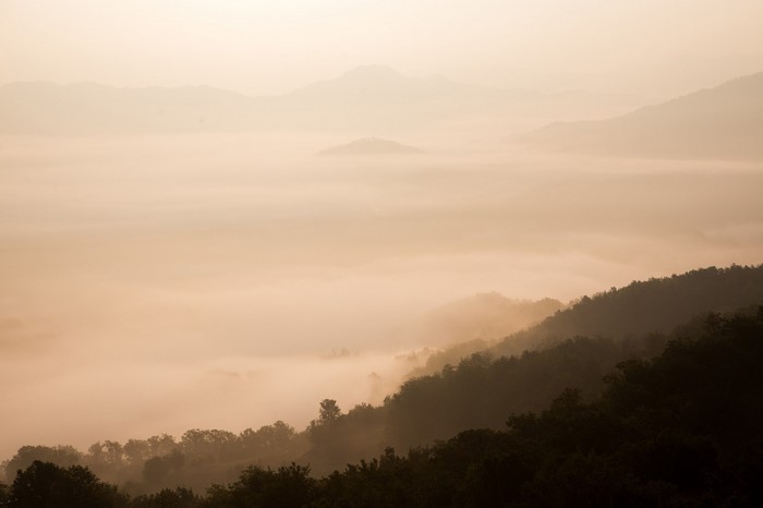Misty mountains at sunrise or sunset