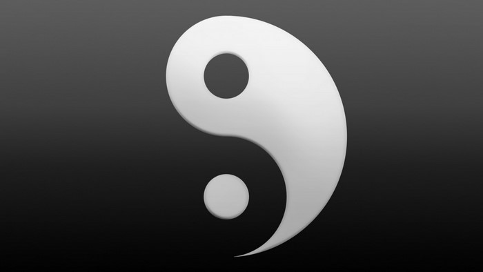 White Yin and Yang symbol on a dark background