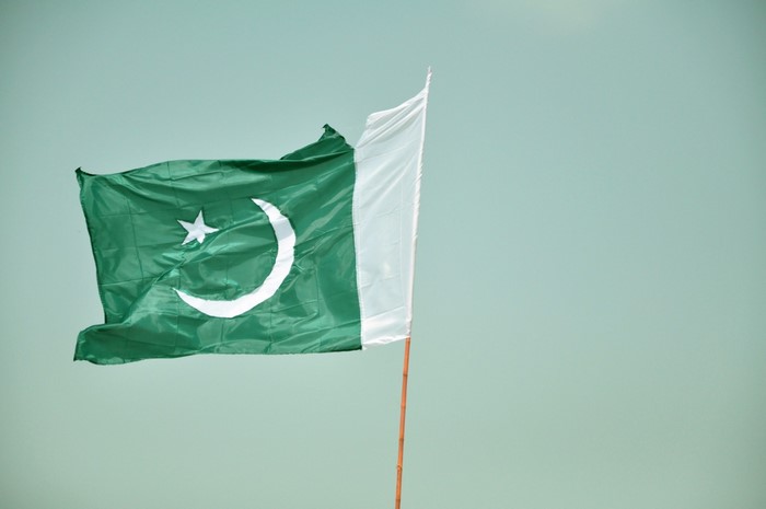 Pakistan flag waving against a light blue sky