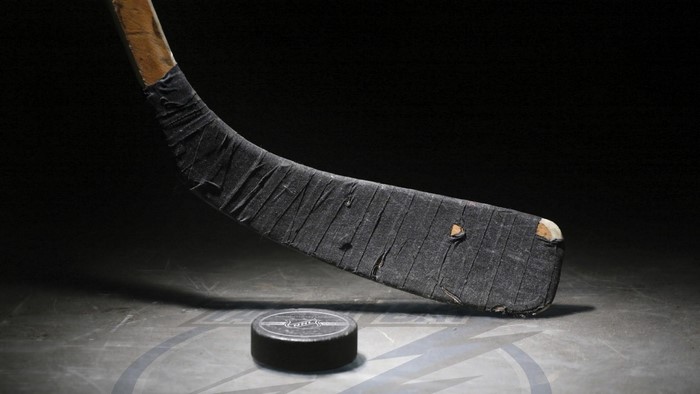 Hockey stick and puck on ice