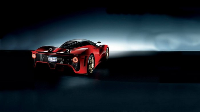 Red Ferrari sports car with license plate 612 P4-5