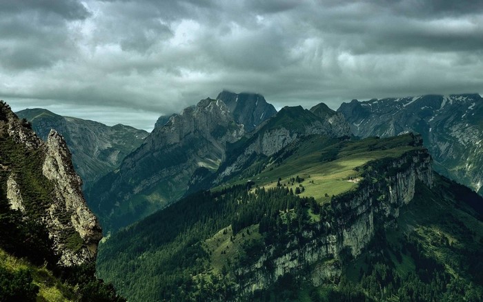 Mountain range with dramatic clouds and valleys
