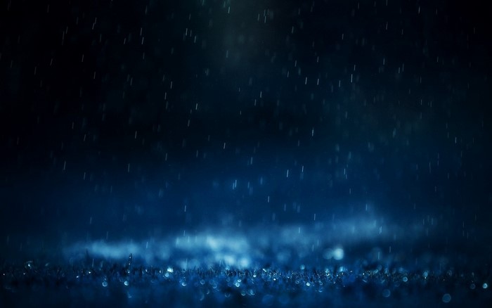 Rain falling at night with bokeh lights