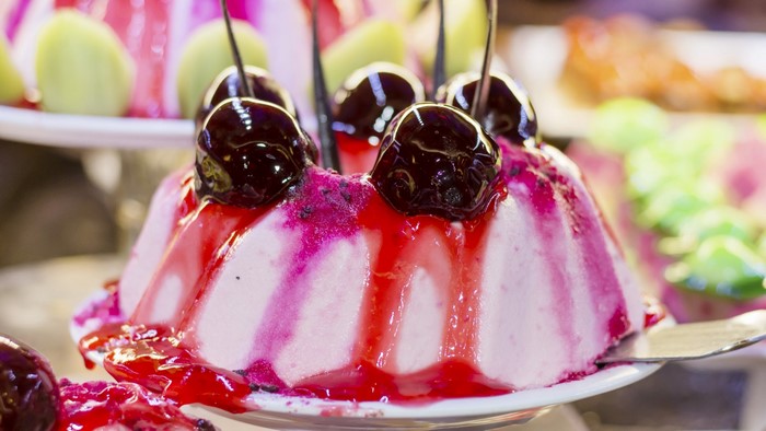 Pink dessert with cherries and fruit slices