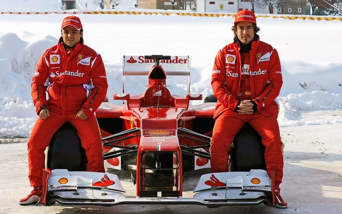 Felipe Massa and Fernando Alonso with Ferrari Formula 1 car in snow