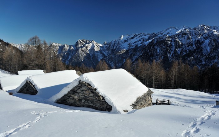 Snow-covered stone huts in the Alps