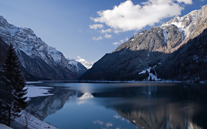 Snow-capped mountains reflected in a calm lake