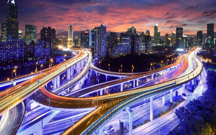 Cityscape with traffic light trails at dusk