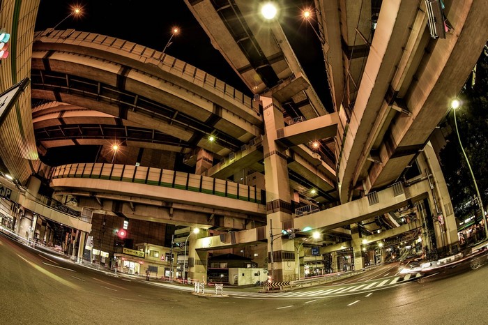 Nighttime fisheye view of a complex highway interchange in Tokyo