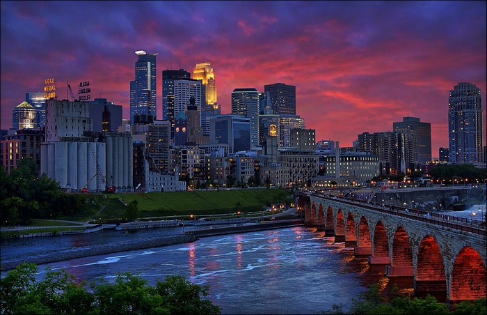 Minneapolis skyline at sunset over the Stone Arch Bridge
