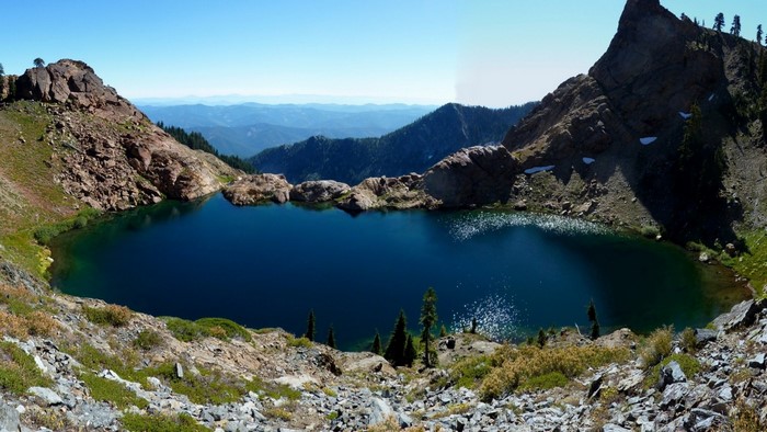 Deep blue alpine lake surrounded by rocky mountains