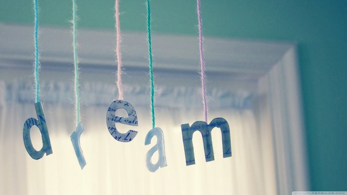 Letters spelling DREAM hanging on strings