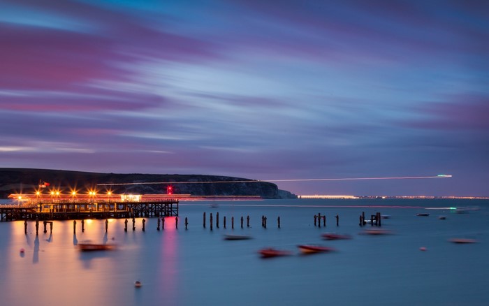 Pier with lights over the sea at dusk