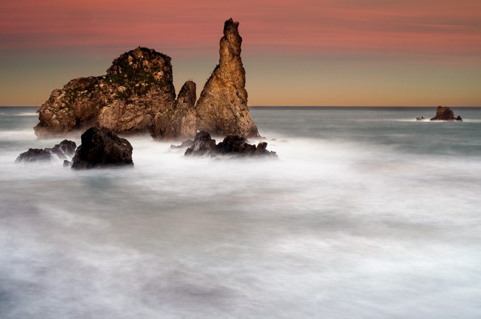 Rocky coast with waves at sunset