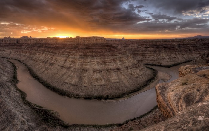 Canyon river at sunset with dramatic clouds