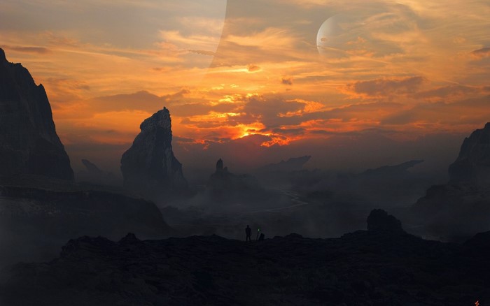 Two figures stand on a rocky outcrop during a dramatic sunset on an alien planet with a large moon.