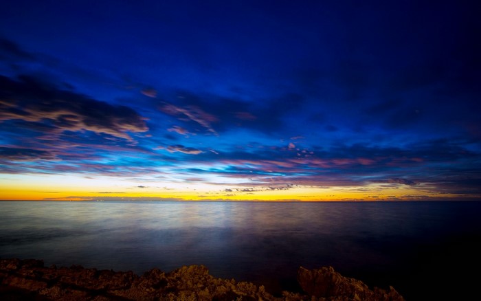 Sunset over the ocean with dramatic clouds