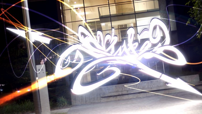 Graffiti art with light trails in urban setting