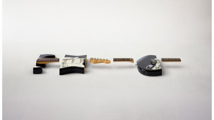 Disassembled electric guitar parts on a white background