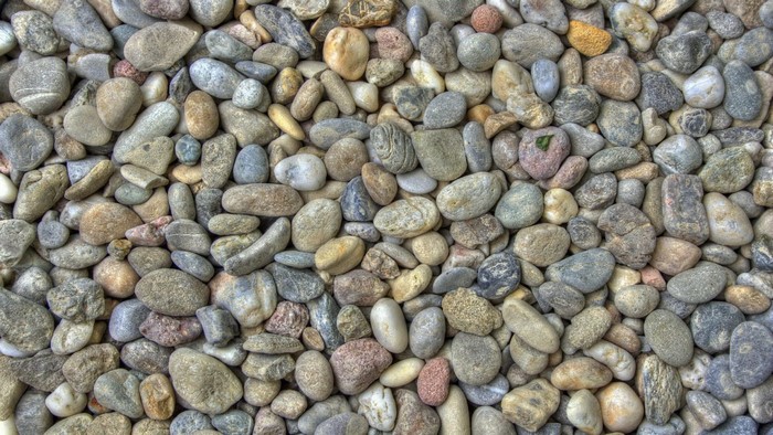A pile of various sized and colored stones and pebbles