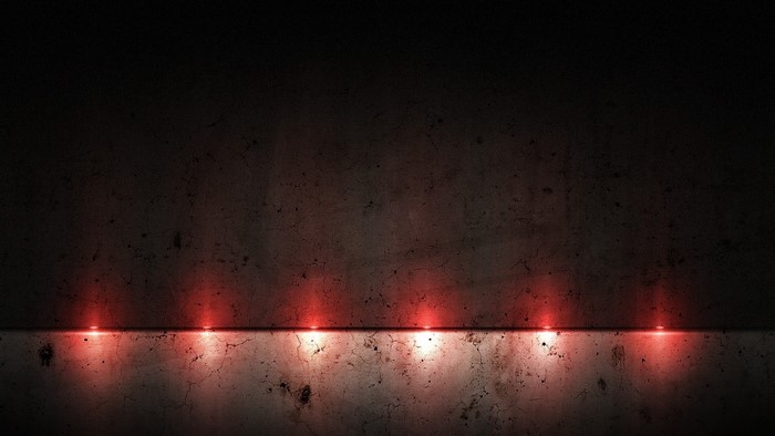 Dark concrete wall with red lights