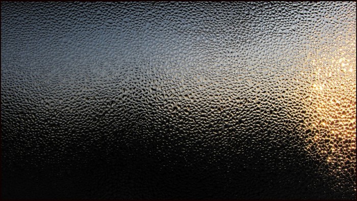 Textured glass with sunlight and darkness