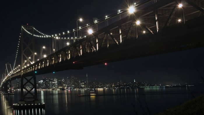 Oakland Bay Bridge at night with San Francisco cityscape