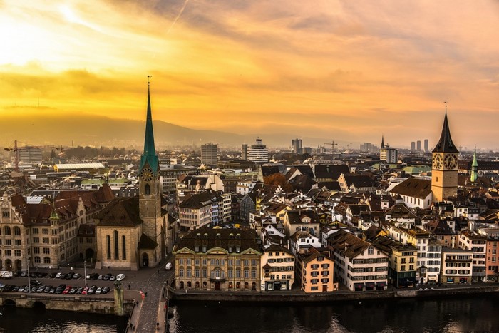 Zurich cityscape at sunset with Fraumunster and Grossmünster churches