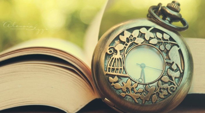 Pocket watch on an open book