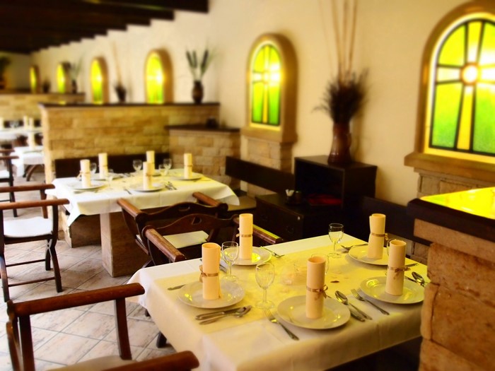 Restaurant interior with tables set for a meal