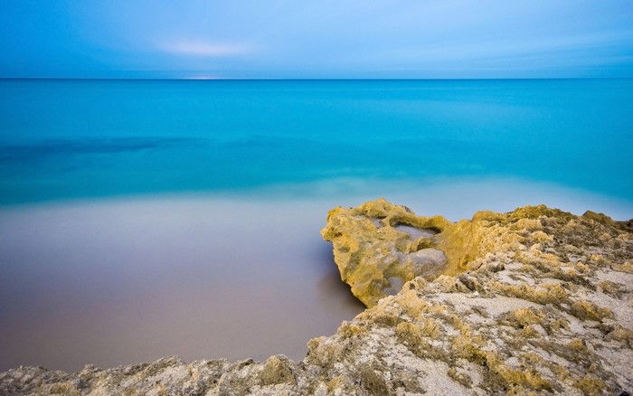 Ocean horizon with rocky shore and calm water