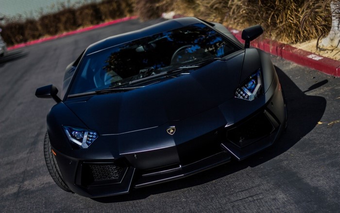 Black Lamborghini Aventador parked on asphalt