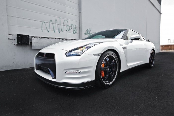 White Nissan GT-R R35 parked by a wall