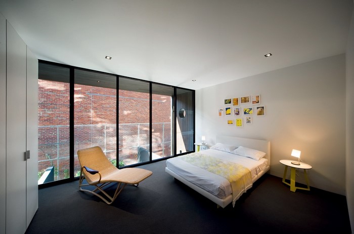 Modern bedroom with large window and chaise lounge