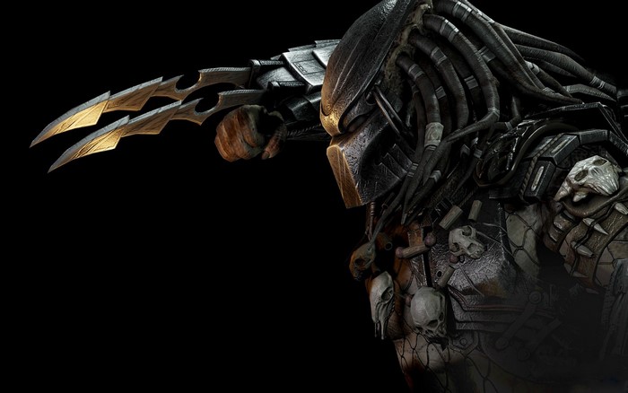Predator with wrist blades and skull trophies