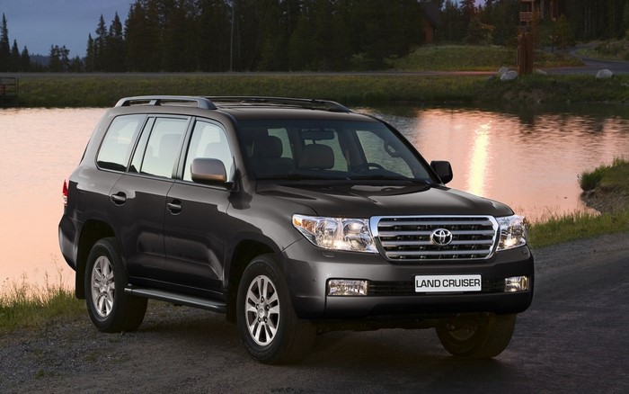 Dark gray Toyota Land Cruiser parked by a lake