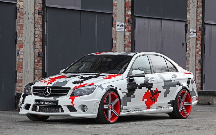 Mercedes-Benz C63 AMG with custom camouflage wrap and red wheels