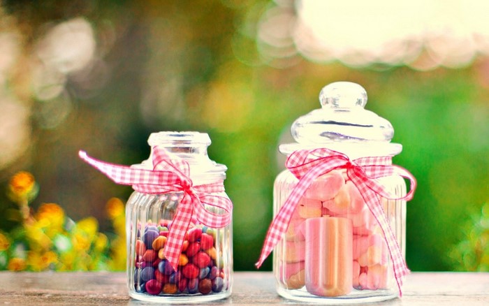 Two glass jars filled with candy and marshmallows
