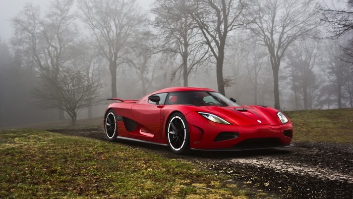 Red Koenigsegg Agera R supercar in foggy forest