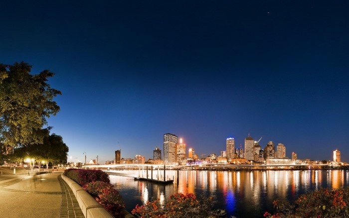 Cityscape skyline at night with river reflections