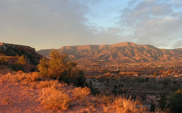 Sunset over a valley with mountains and a plateau