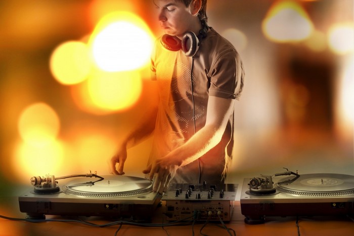 DJ with headphones playing turntables